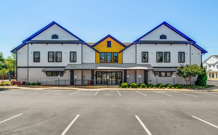 the collective at auburn luxury off campus cottage apartments near auburn university leasing office and resident clubhouse exterior